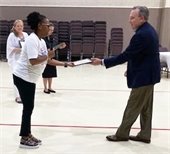 Raising the Bridge hands certificate to city manager cliff keheley