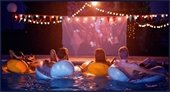 people floating on the water watching a film