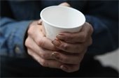 hands holding a cup out for money