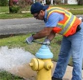man flushing a hydrant