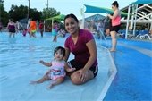 a mom and her baby girl play in the pool at the dive-in movie