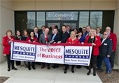 Chamber of Commerce and Council members performing ribbon cutting in front of Elements International