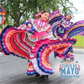 Girls dancing in colorful traditional Hispanic dresses