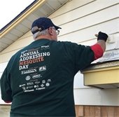 volunteer helps remove tree on addressing mesquite day