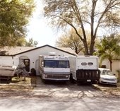 RV and large trucks parked in driveway