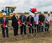 City Council, City Manager and Iron Horse developers posed with ground breaking shovels, wearing hard hats