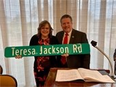 Mayor Pickett presenting road sign to Teresa Jackson