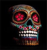 Black sugar skull with Day of the Dead-themed painting