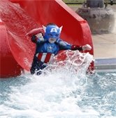 Kid dressed up in a Captain America takes the polar plunge