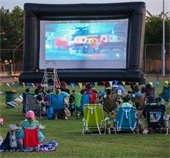 people sitting outside at park for Movies in the Park