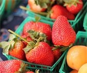 Baskets of strawberries and oranges at The Marketplace 