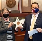 Elizabeth Harrell and Mayor Bruce Archer holding the award 