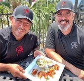 Alejandros owners with plate of food
