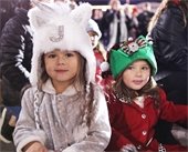 Two young girls smiling at camera during a holiday event in Mesquite