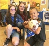 kids with dog they adopted