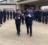 officers salute as K9 Kozmo's ashes are carried to car