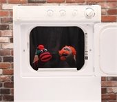 behind the dryer, two socks in a dryer