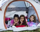 Three young girls pictured hanging out in camping tent