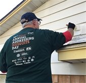 man paints house at Addressing Mesquite Day