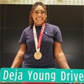 Deja holding street sign named after her