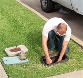 man working on water meter