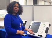 Dallas County representative pictured with new voting equipment
