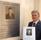 Mayor Venner standing next to plaque