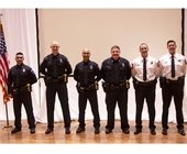 Six new Mesquite Police Department recruits standing side by side with American flag on far left