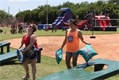 Two women playing a Texas-size game at Summer Sizzle 2018