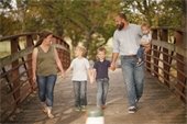 Family walking across a bridge
