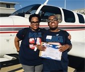 Child and his mother pictured in front of an airplane
