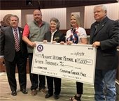 Members of Operation Forever Free pictured with Mayor Stan Pickett holding $15,000 mock check