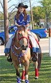 Girl riding horse during previous Mesquite Rodeo Parade