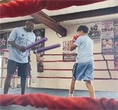 officer and student in boxing ring at camp