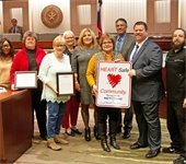 Mesquite Heart Board pictured with Mayor Bruce Archer holding the Heart Safe Community sign