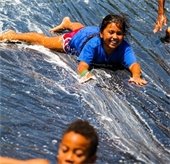 girl sliding on a slip and slide