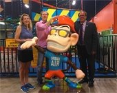 Photo of Councilmember Tandy Boroughs posing with Urban Air owners