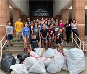 Young trash bash volunteers pictured with bags of trash collected